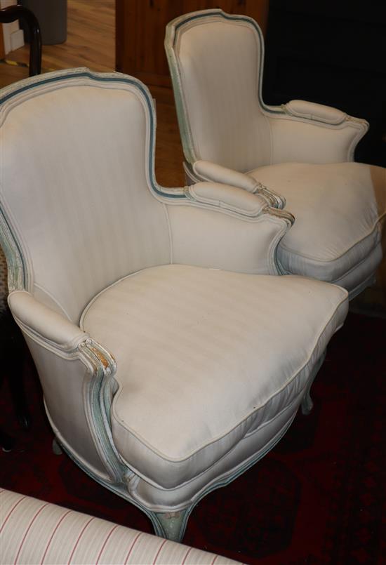 A pair of Louis XV style painted framed fauteuil, with white linen upholstery